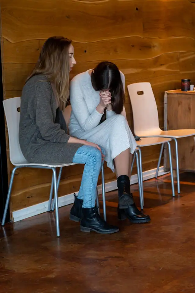 Two women praying together