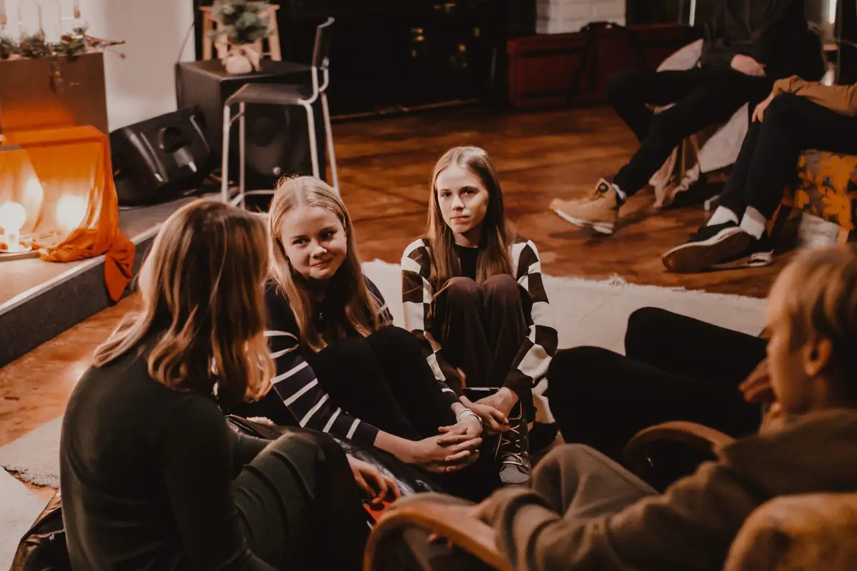 Young people talking by candlelight
